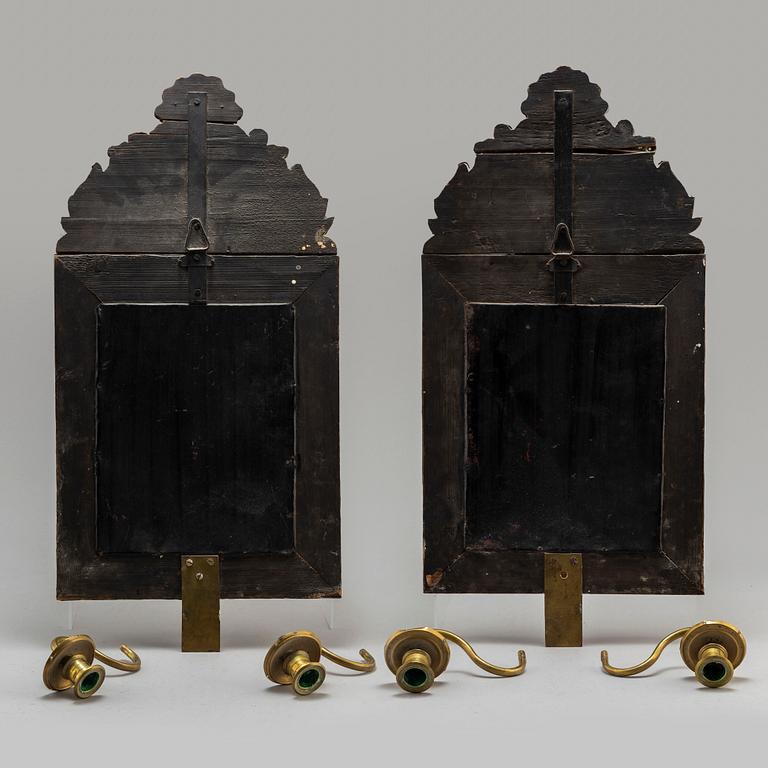 An early 20th Century pair of baroque style mirror sconses.