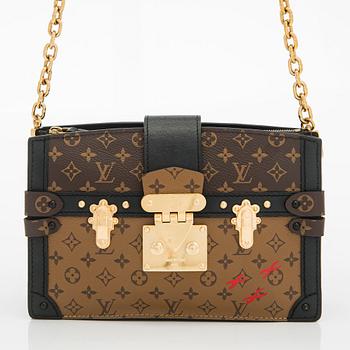 Louis Vuitton, a "Reverse Monogram Trunk Clutch" bag.