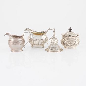 A silver bell, sugar box, and two creamers, including London 1811.
