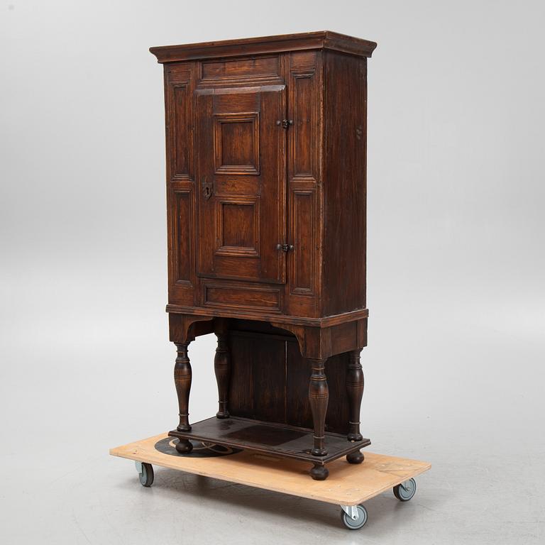 A Baroque cabinet on a later stand, early 18th Century.