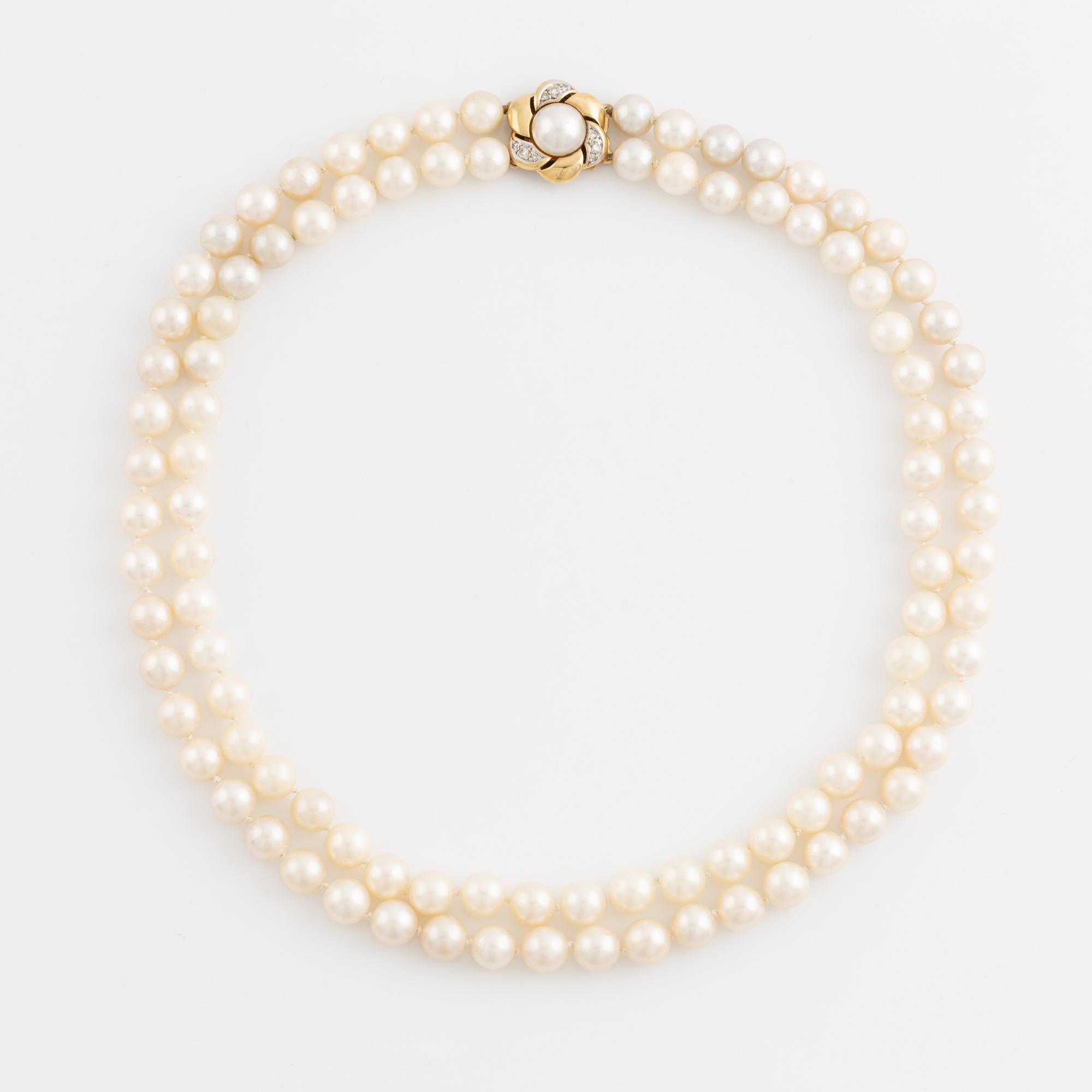 Two strand cultured pearl necklace, clasp 18K gold with half pearl and eight cut diamonds.