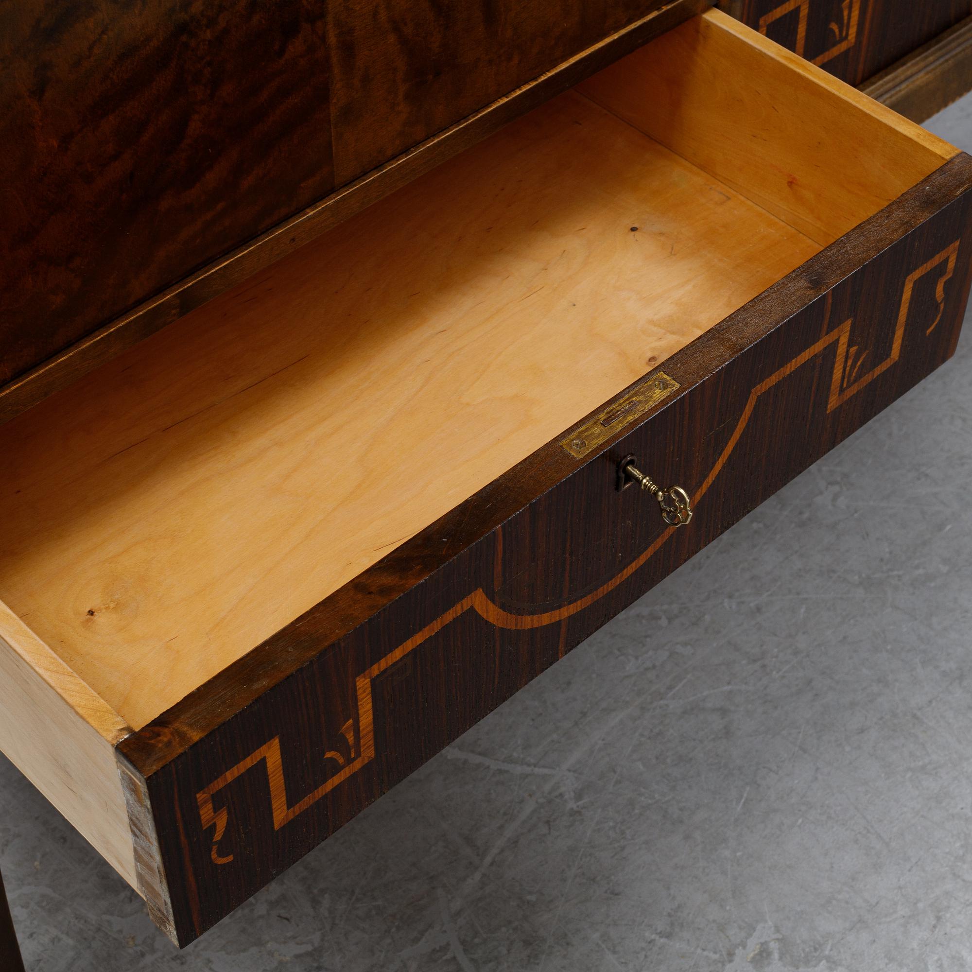 A 1920's-30's Swedish Grace birch and rosewood veneered cabinet.