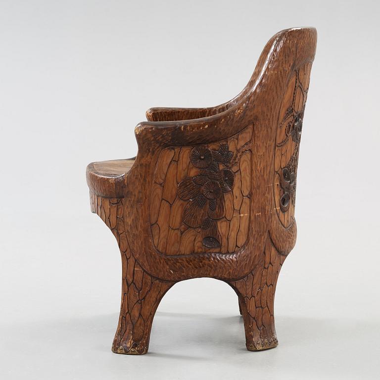 A Gustaf Fjaestad Art Nouveau carved pine chair, 'Stabbestol', by Adolf Swanson, Arvika, Sweden 1908.