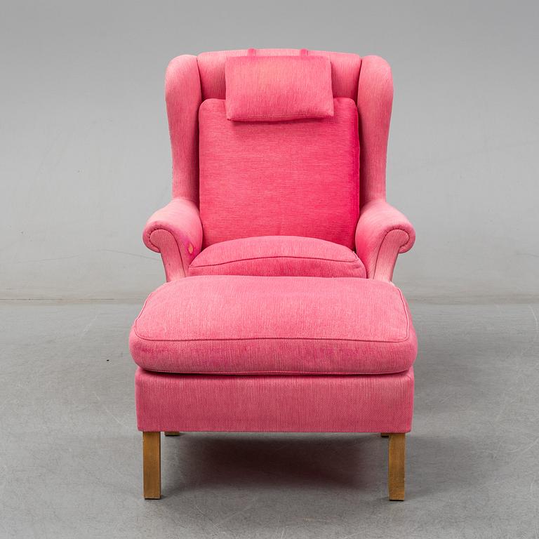An 'Oxford' model no 3543 easy chair with stool by Ragnar Helsén for Firma Svenskt Tenn.
