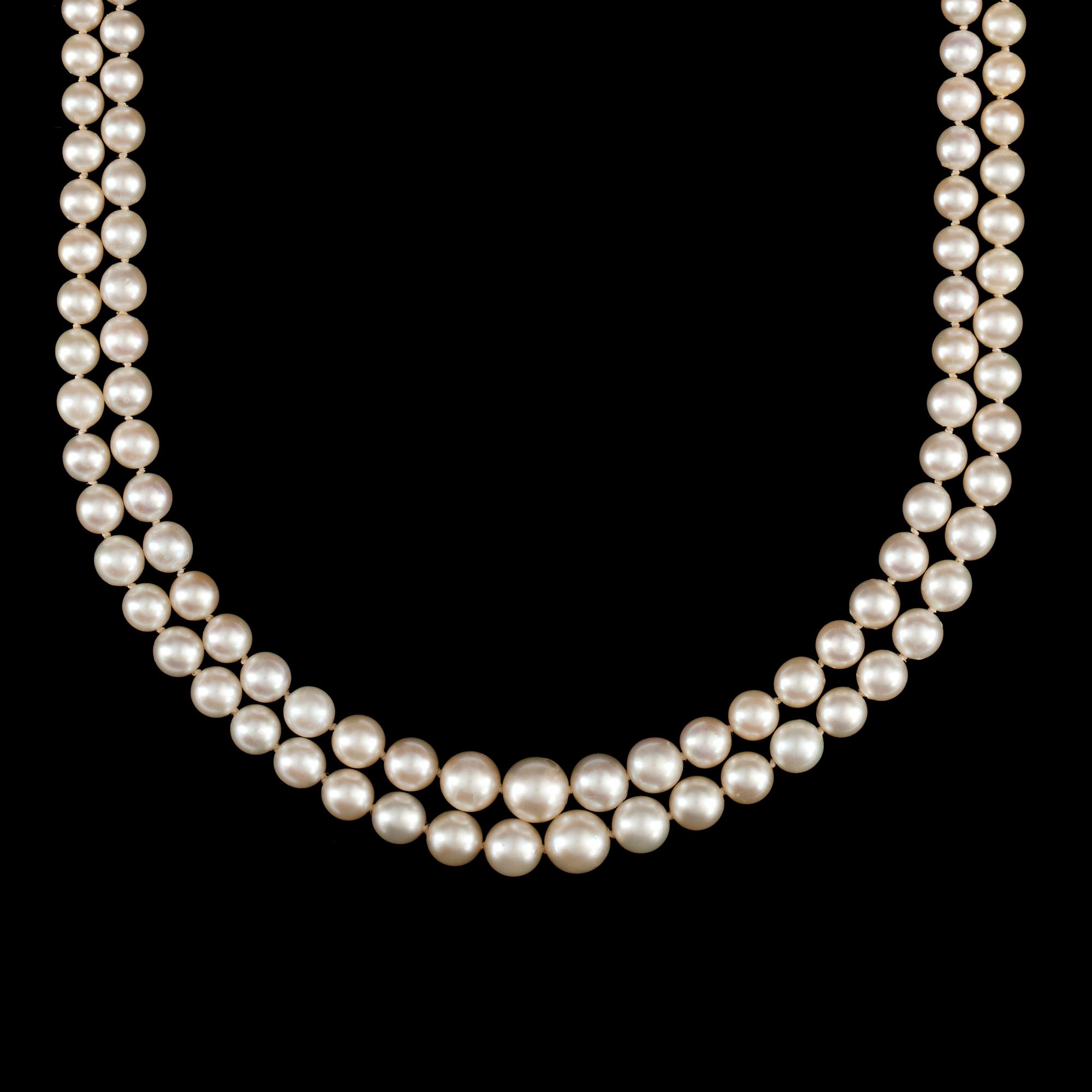 A 2-strand cultured pearl necklace. Clasp in the shape of the letters 'EJ' set with brilliant-cut diamonds.