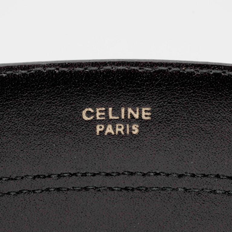 CÉLINE, a striped leather belt.