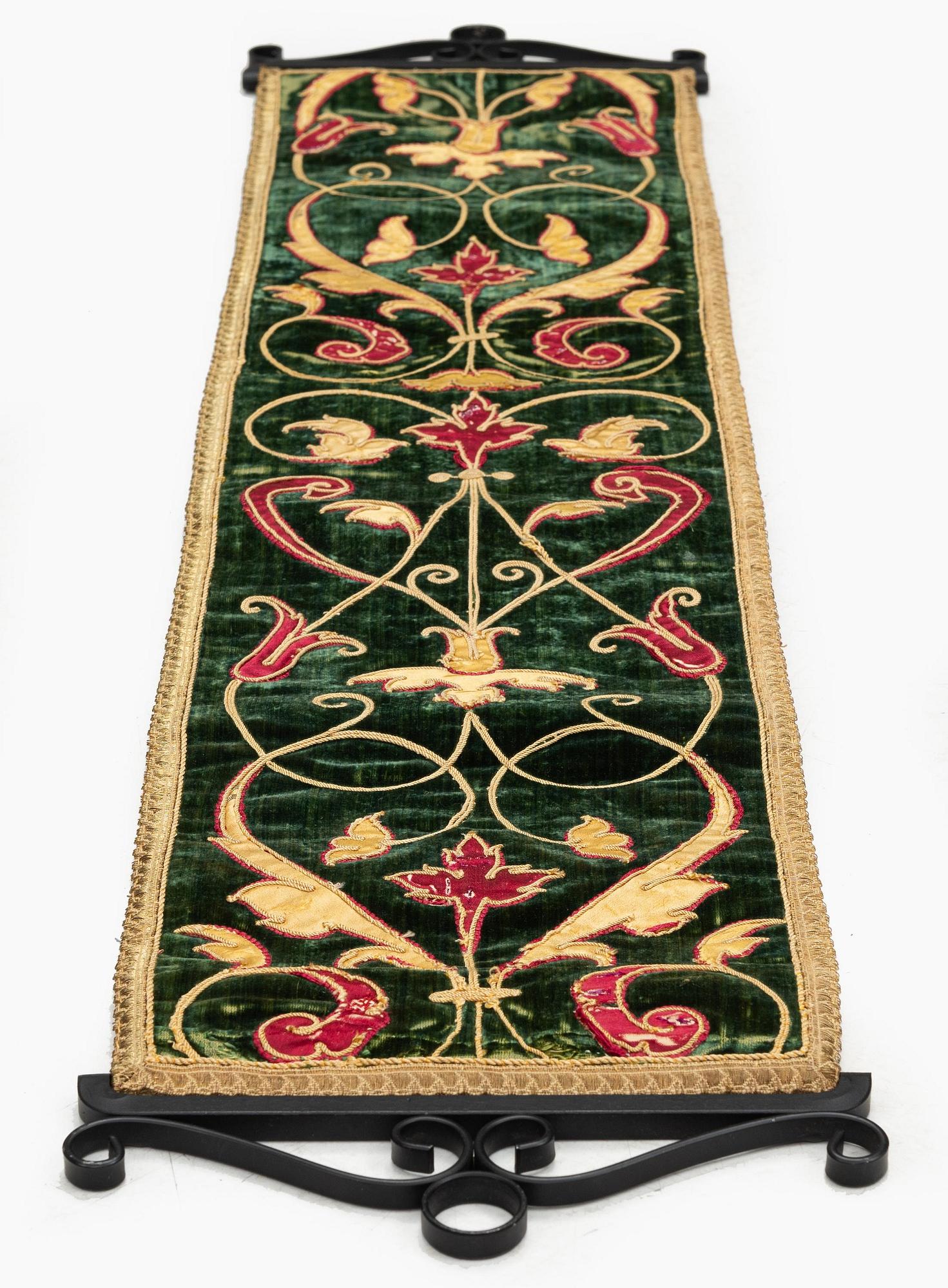 A 17th century Spanish embroidered velvet panel, c. 77 x 18.5 cm.