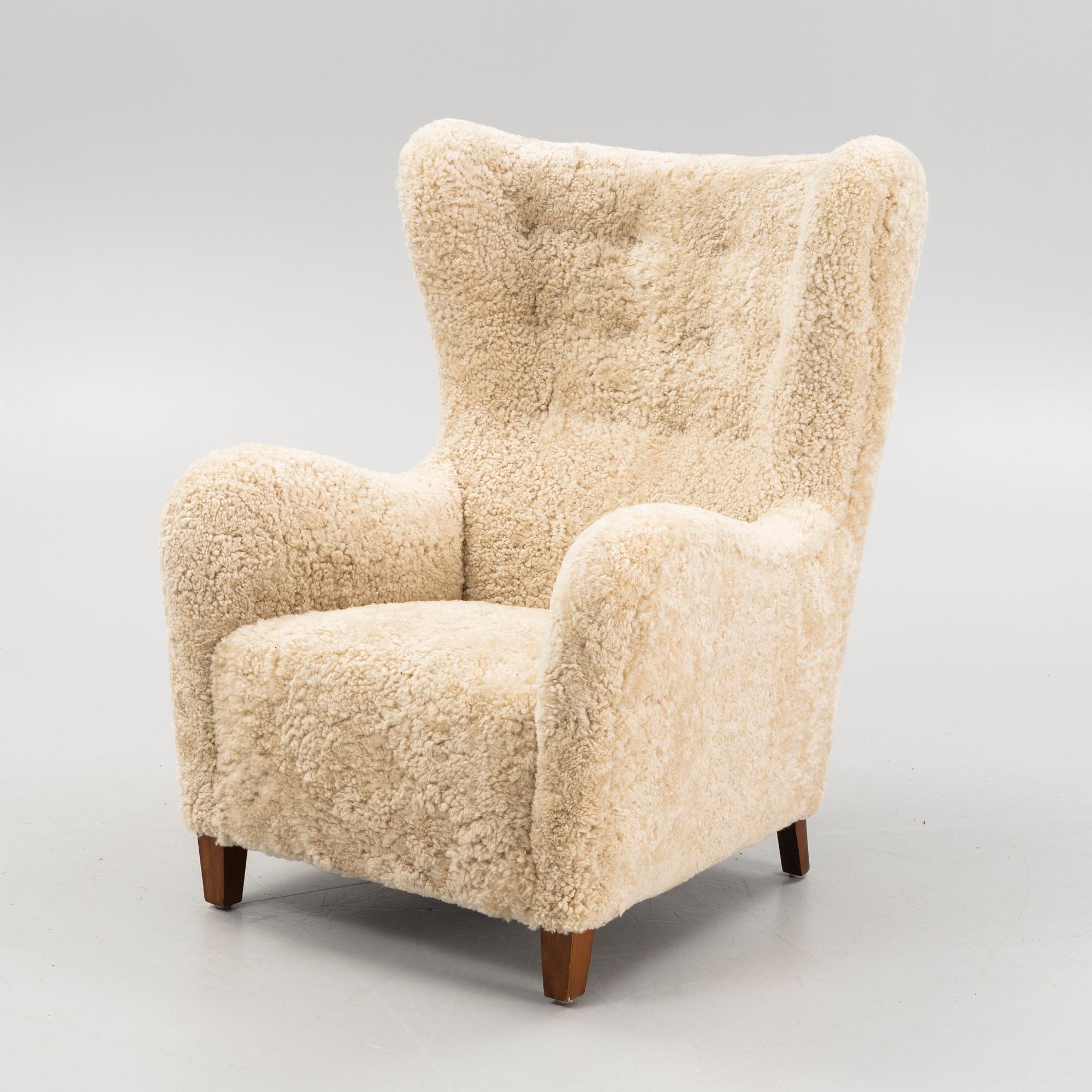 A variation of model 1672 new sheepskin upholstered lounge chair from Fritz Hansen.