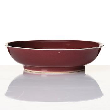 A copper-red glazed dish, Qing dynasty with Qianlong mark and of the period (1736-95).