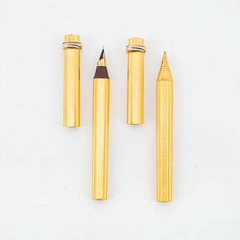 Les Must de Cartier, two gold plated 'Vendôme Trinity' pens.