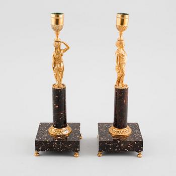 A pair of late gustavian early 19th century porphyry and ormolu candlesticks.