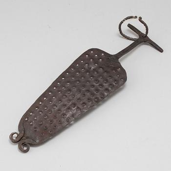 A 18th century iron kitchen tool.
