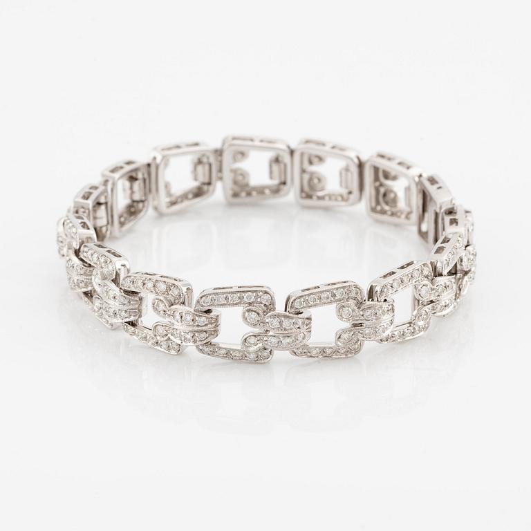 An 18K white gold bracelet set with round brilliant-cut diamonds.