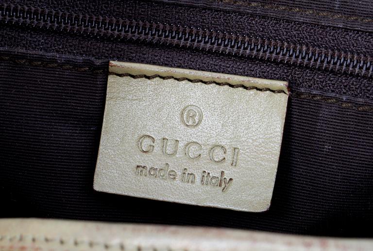 A beige monogram canvas handbag by Gucci.