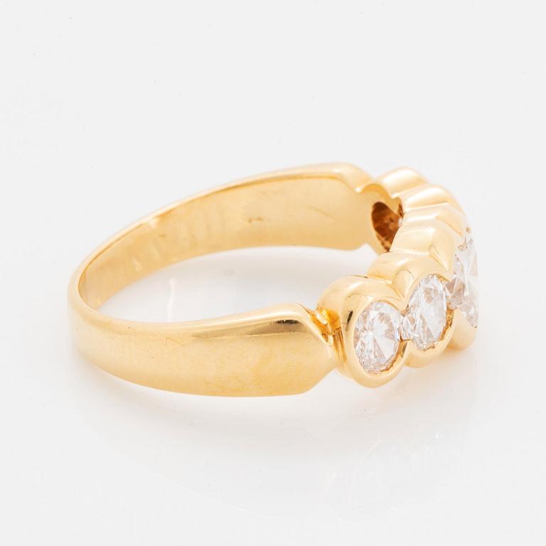 An 18K gold ring set with a heart formed brilliant-cut diamond.