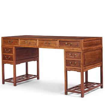 1116. A six-drawer 'jichimu' pedestal partners desk, late Qing dynasty/early 20th century.