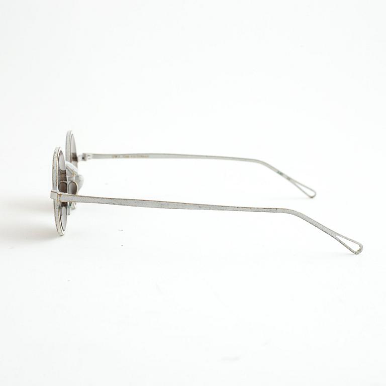 A pair of Uma Wang + Rigards, 'The Victorian', sunglasses and a Uma Wang, ipad case.