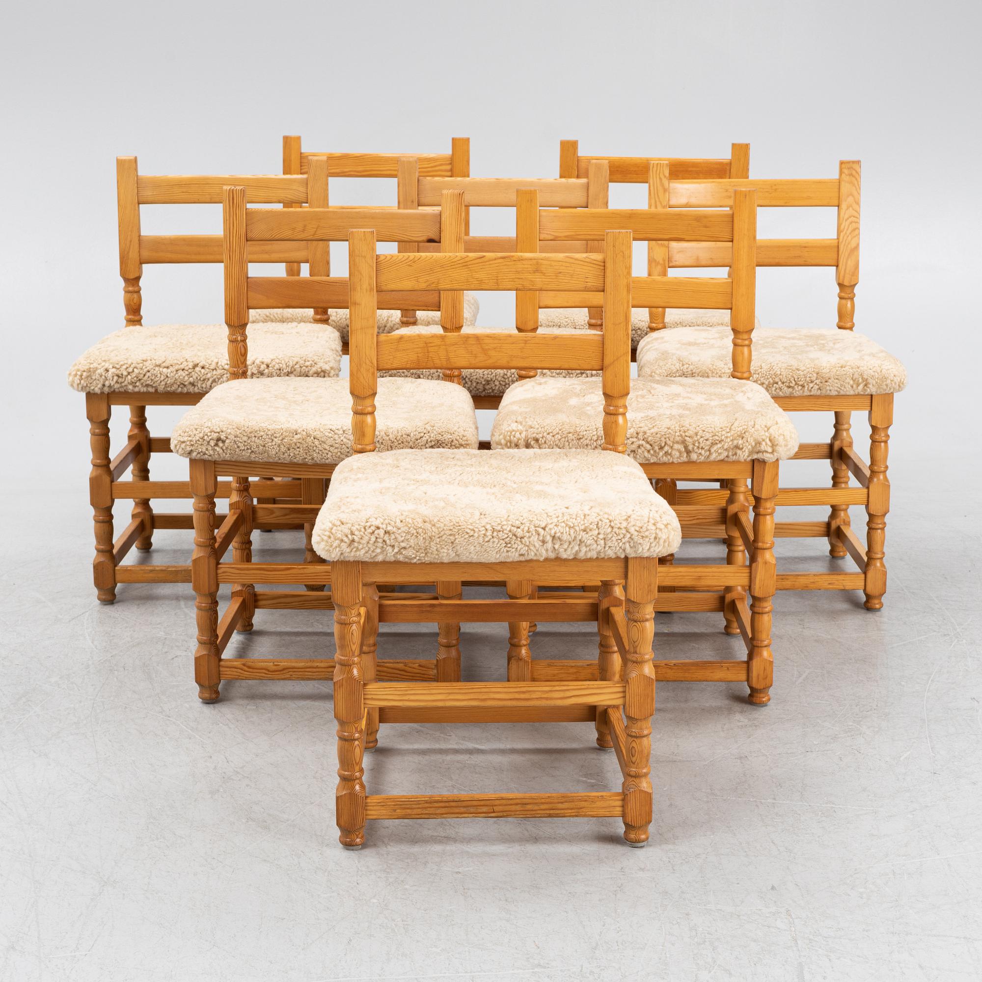 A set of eight pine chairs with new sheepskin upholstery, 1970s.