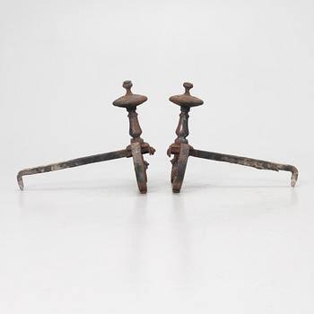 A pair of wrought iron fire dogs.