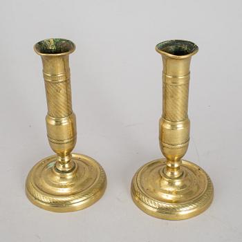 A 19th Century pair of brass candlesticks.
