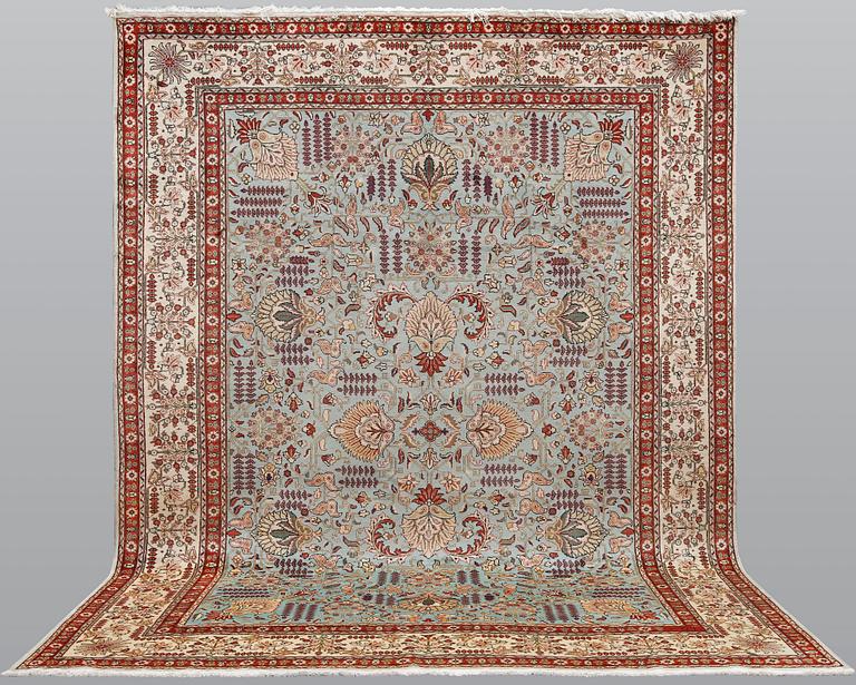 A Tabriz carpet, signed, approx. 390 x 297 cm.