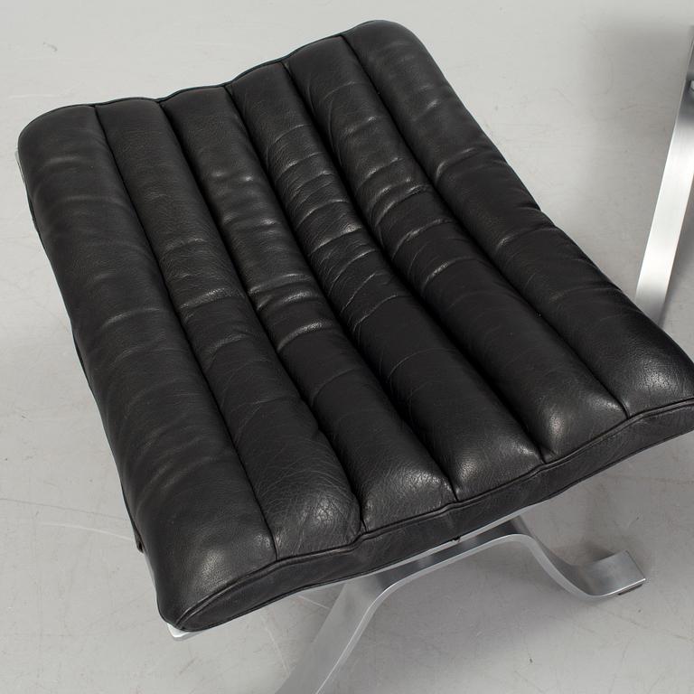 A black leather "Ari" easy chair with foot stool by Arne Norell for Norell möbler.