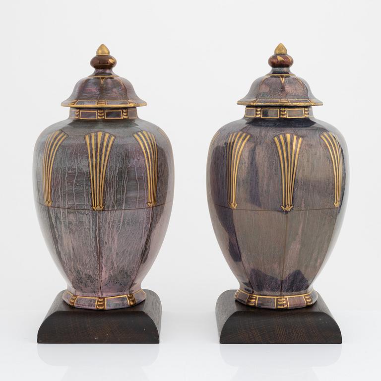 Josef Ekberg, a pair of creamware lidded urns, Gustavsberg, dated 1927.