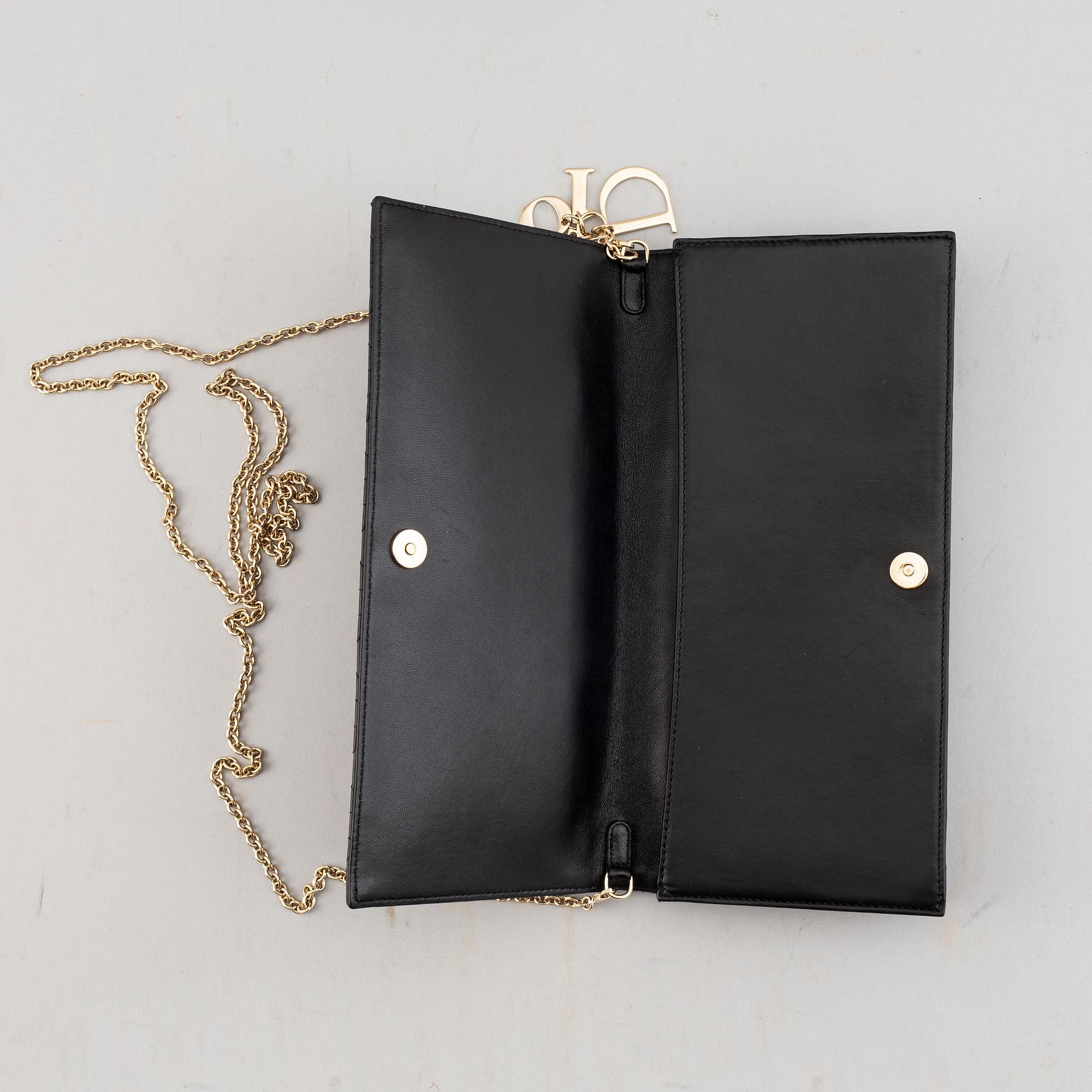 Christian Dior, a quilted leather handbag/clutch.