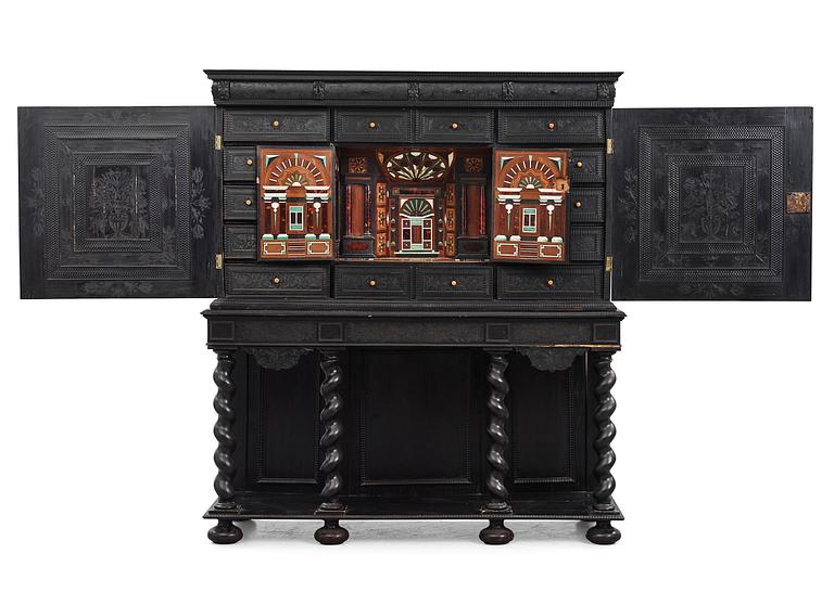 A Louis XIV and Louis XIV-style carved ebony, ivory and tortoiseshell-inlaid cabinet on stand, 17th and 19th century.