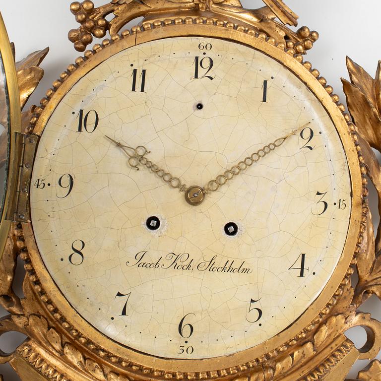 A late Gustavian carved and giltwood cartel clock by J. Kock (royal watchmaker, active 1762-1803).