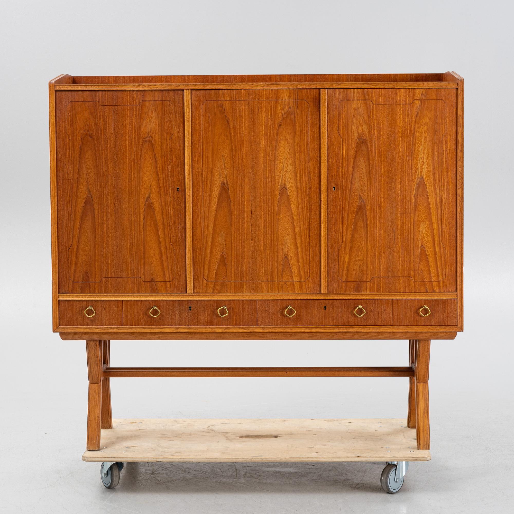 A teak-veneered mid 20th century sideboard.