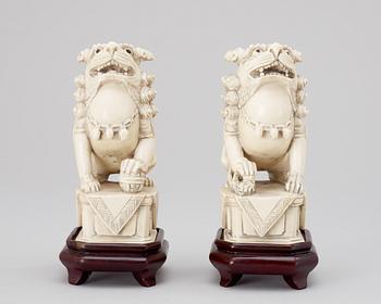 A pair of 20th century ivory figures, China.