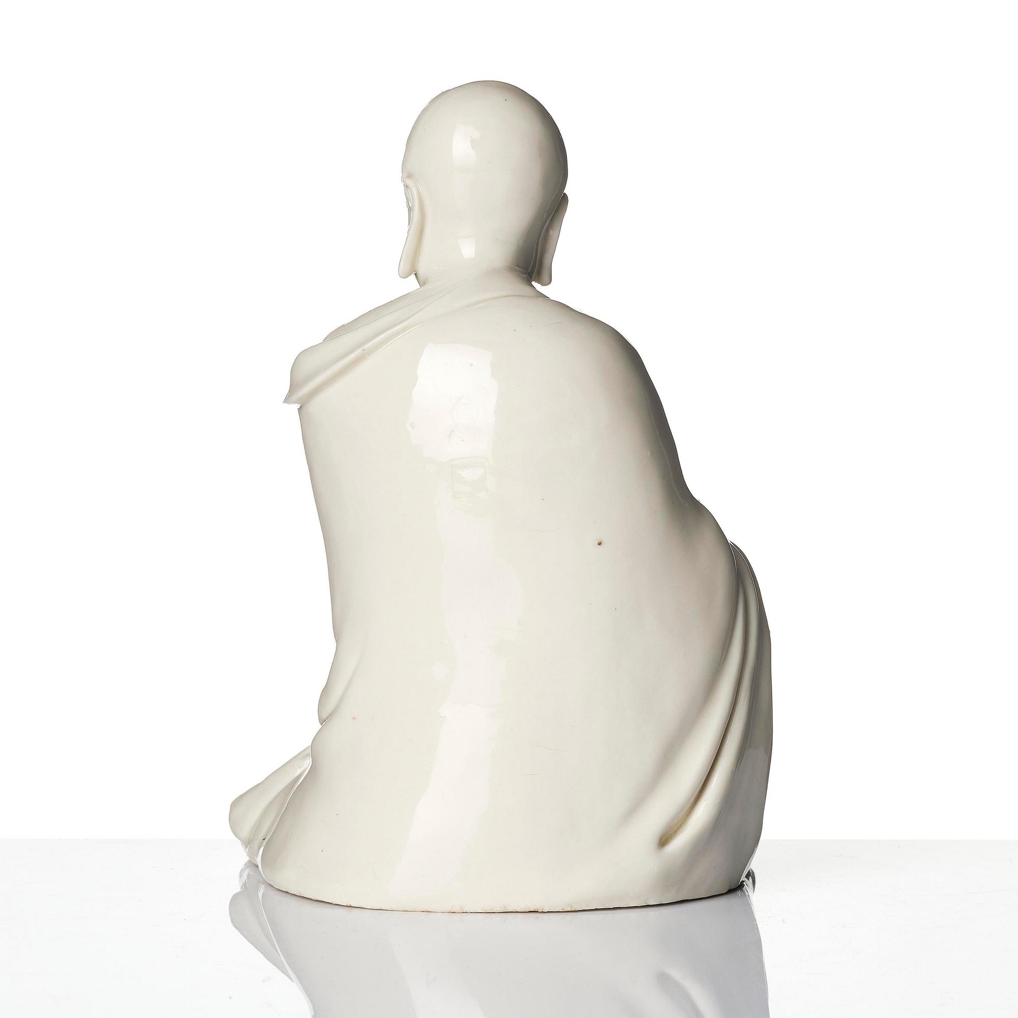 A blanc de Chine seated figure of Bodhidharma, Qing dynasty.
