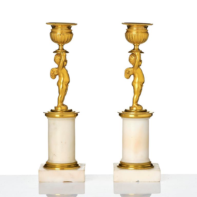 A pair of late Gustavian white marble and ormula candlesticks.