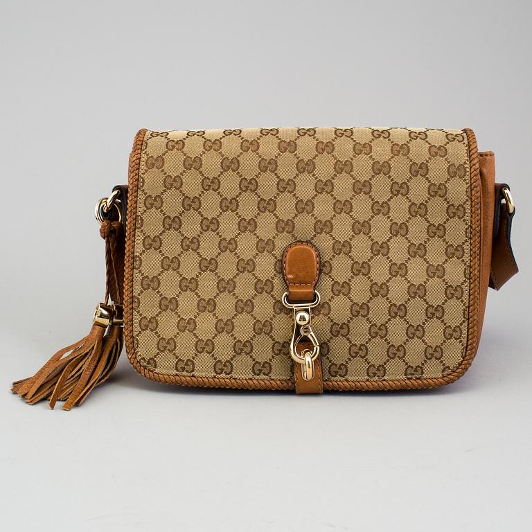 A 'Marrakech Medium Messenger Bag' by Gucci.