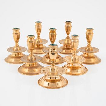 A set of eight brass baroque-style candlesticks from FMM Mora, later part of the 20th century.