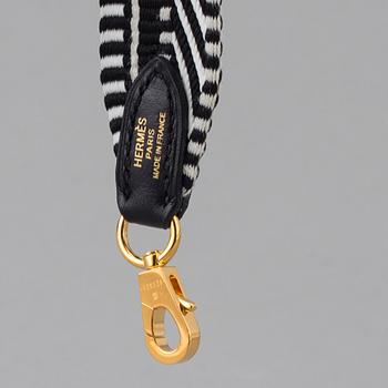 A bag strap by Hermès.