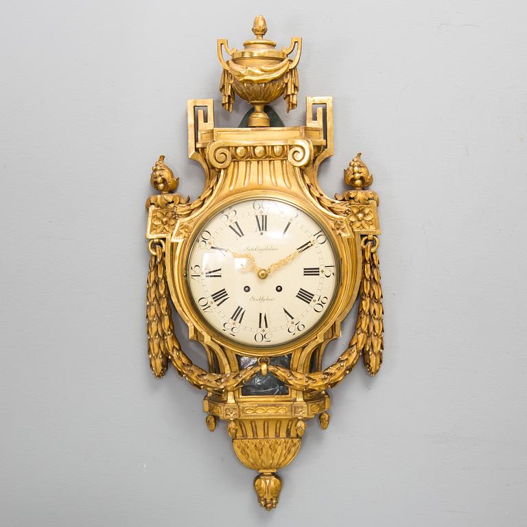 A wall clock in gustavian style, marked Rob. Engström, Stockholm.
