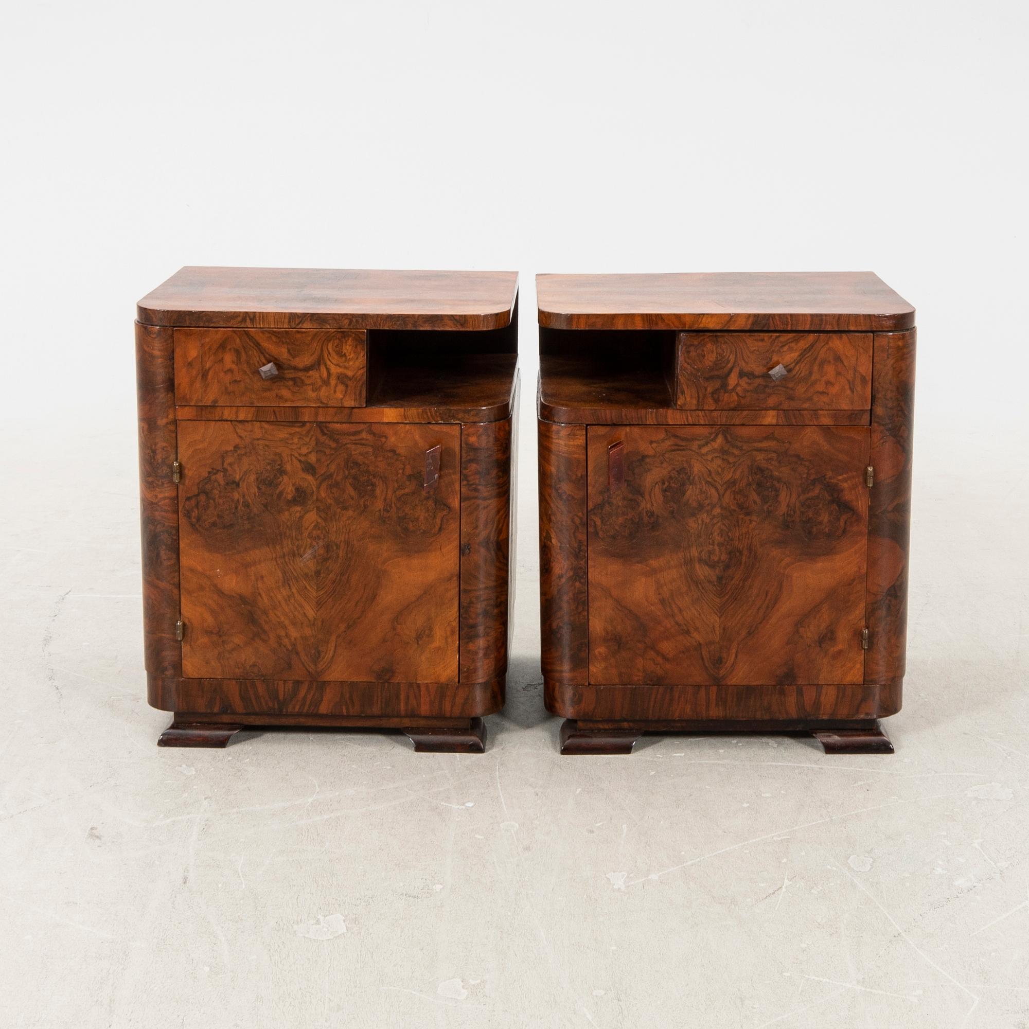 A pair of Art Deco walnut bedside tables.