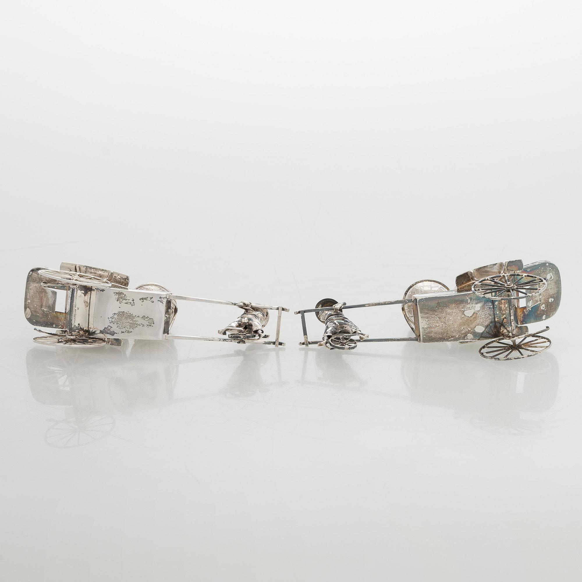 Four shakers in a pair of miniature rickshaws, sterling silver, maker's mark of Wai Kee, Hong Kong.