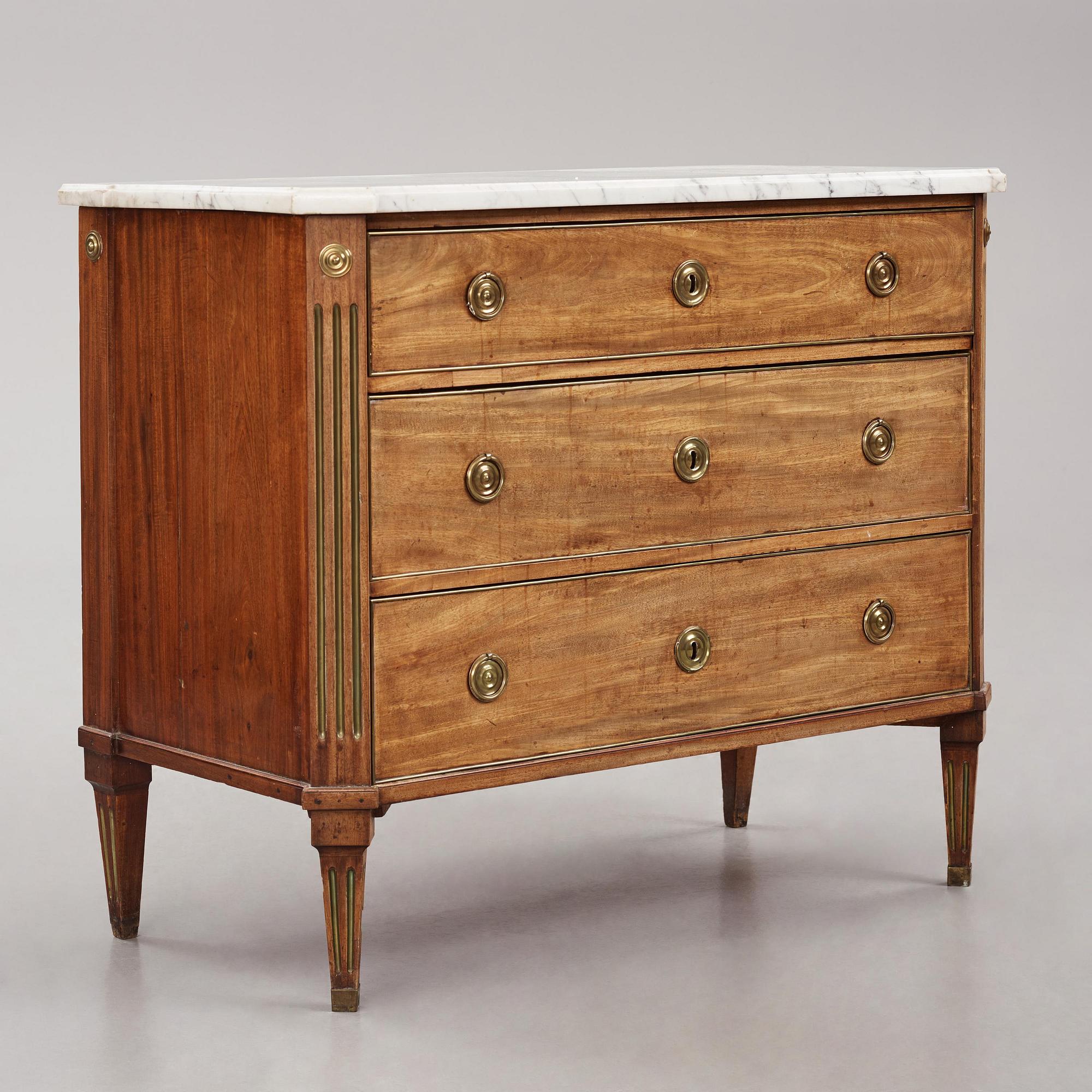 A late Gustavian mahogany, marble top, and brass-mounted commode, Stockholm, late 18th century.