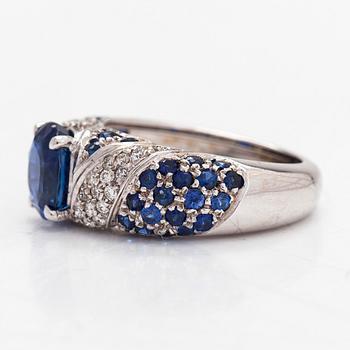 An 18K white gold ring, with diamonds totalling approximately 0.22 ct and sapphires.