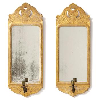 115. A matched pair of rococo giltwood one-branch girandole mirrors, Stockholm, late 18th century.