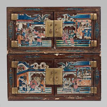 635. A lacquered cabinet, in two sections, Qing dynasty, 19th Century.