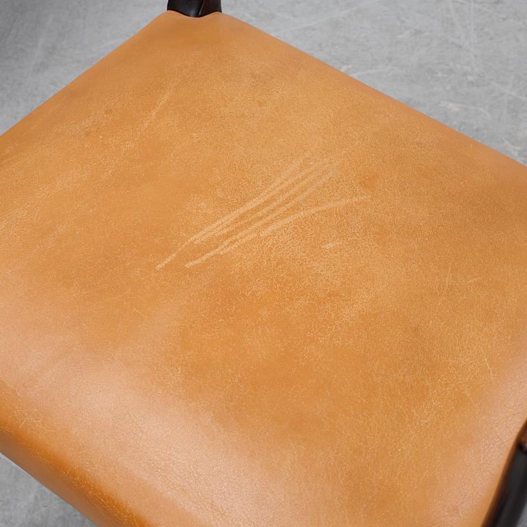 A set of four black stained beech tree arm chairs with leather upholstery, second half of the 20th century.