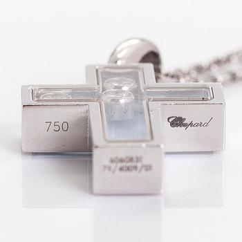 Chopard, an 18K whitegold 'Happy Diamonds" cross necklace set with diamonds.