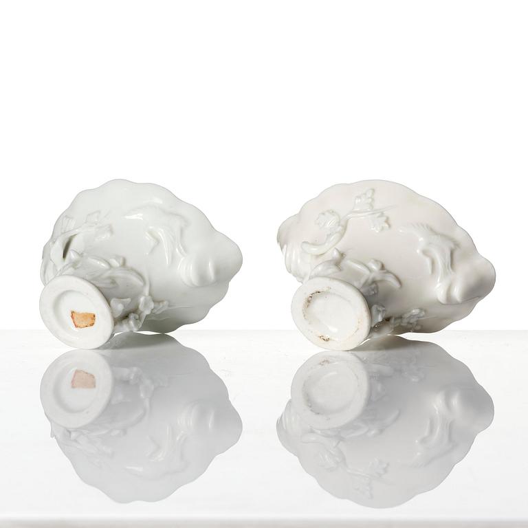 A pair of blanc de chine rhinoceros libation cups, Qing dynasty, Kangxi (1662-1722).