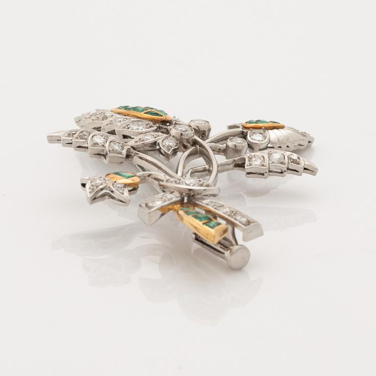 Platinum and gold with brilliant cut diamonds and emerald brooch.