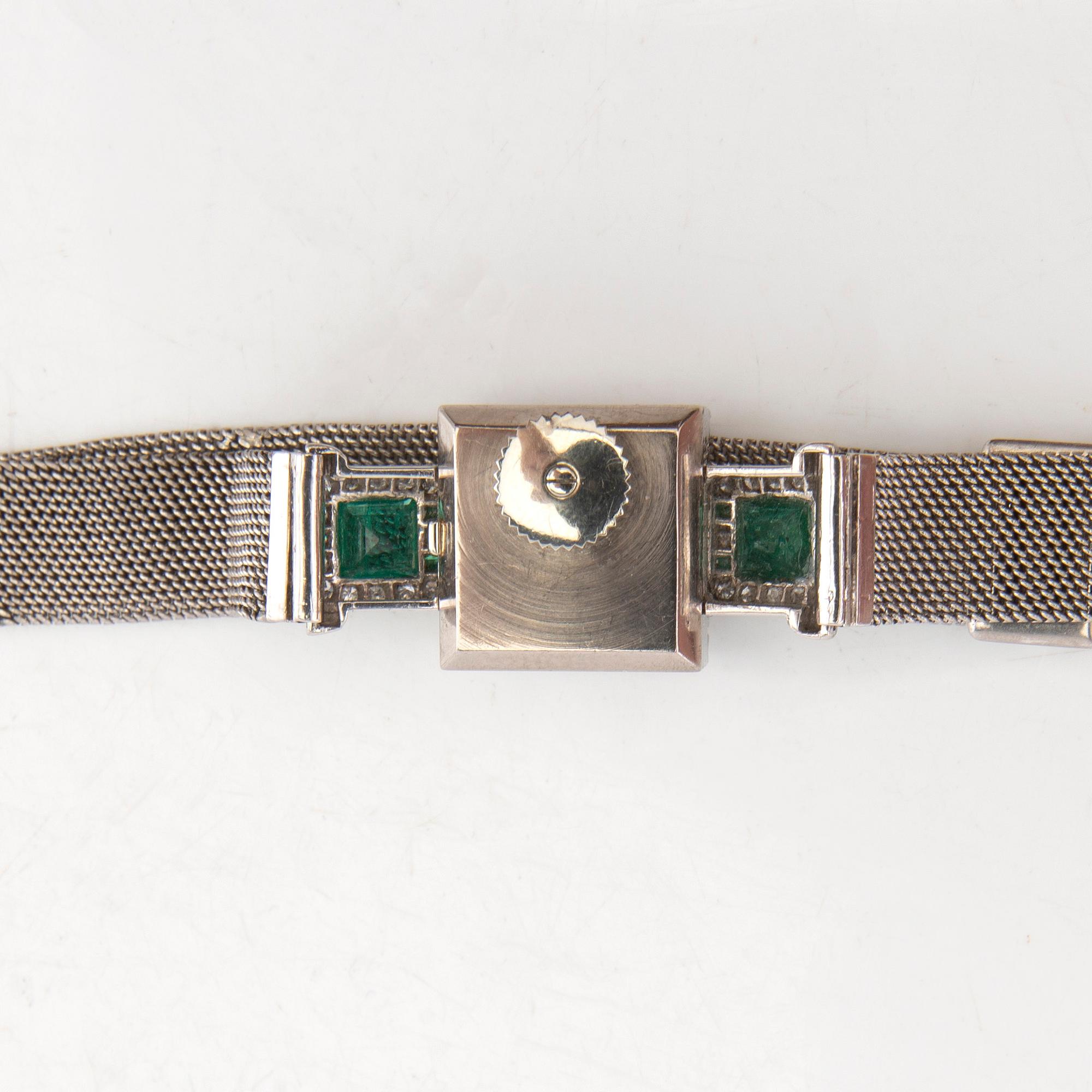 Gübelin bracelet watch in 950 platinum with round brilliant-cut and single-cut diamonds as well as step-cut emeralds.