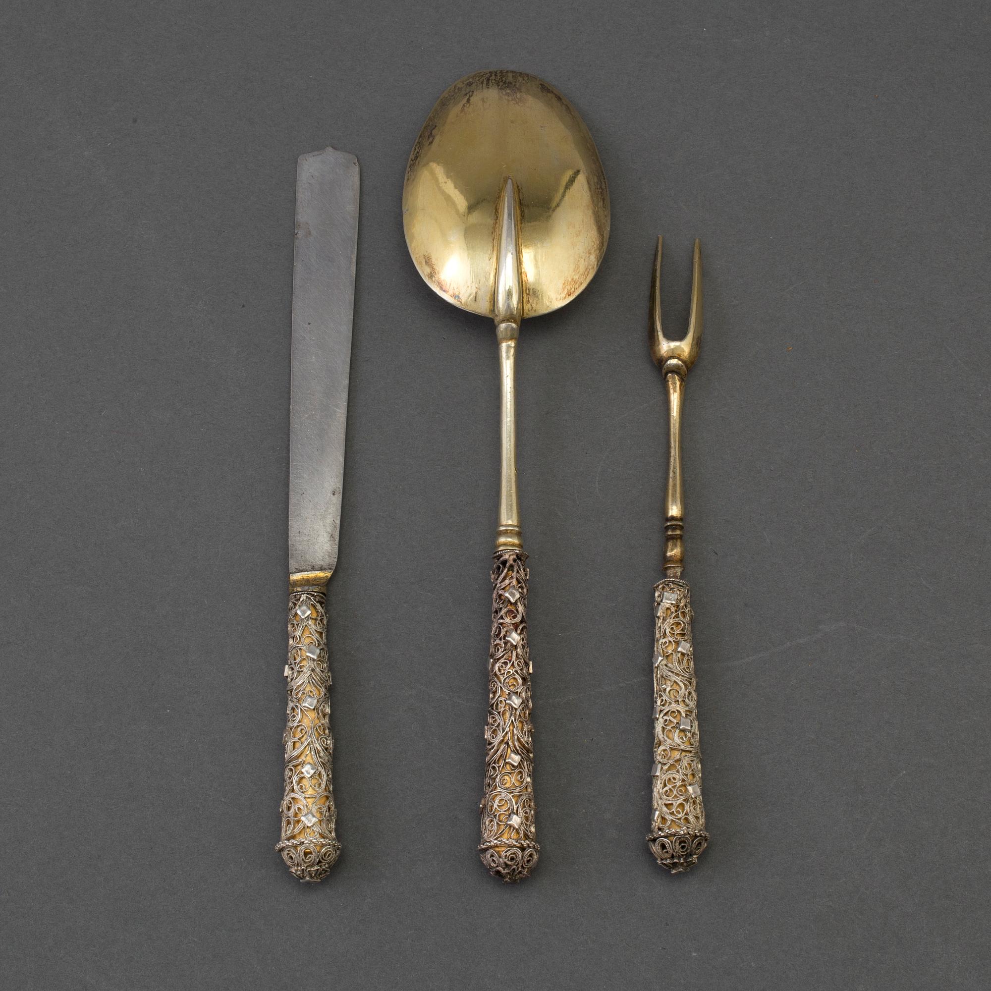 A German 17th century silver-gilt and filigree three-piece travel cutlery, unmarked.